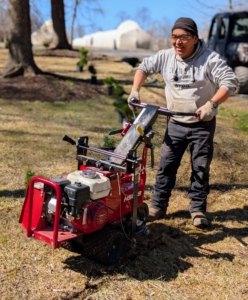 Here's Phurba cutting the sod around the space. There are different types of sod cutters, but they all essentially cut grass at the roots so entire sections of sod can be removed to expose the bare ground underneath it.