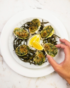 We also offer Oysters Rockefeller, baked with Pernod cream, spinach watercress, and a parsley breadcrumb topping.