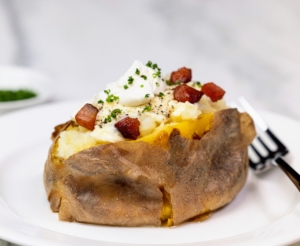 The most popular side dish to any entrée is my Smashed Baked Potato - smashed table-side and served with crème fraîche, chives, and bacon lardons. One can also enjoy with added Golden Ossetra Caviar* and sour cream.