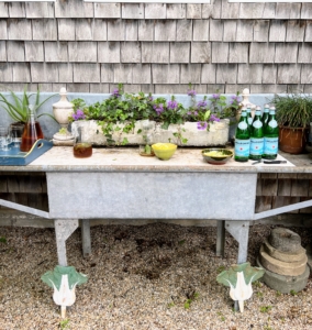Outside, refreshing beverages are served on this antique metal gardening table. It is also a great spot for displaying various potted plants.
