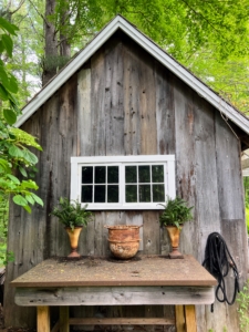 The side of the shed is also very charming. A potting table is situated just right for summertime gardening tasks.