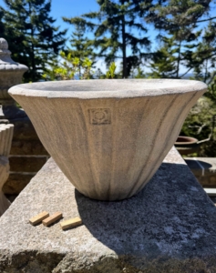 Then it's planting time. The containers and plants are carefully positioned in or close to where they will be displayed for the season. The small pieces of wood are shims which will be placed under each pot. This is a Lunaform vessel. Lunaform is a coastal Maine studio where beautiful handmade garden containers are made.