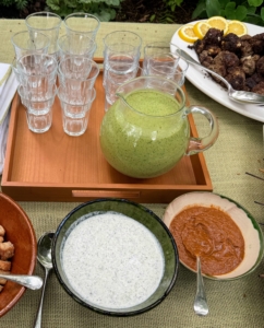And green gazpacho - a chilled soup made from cucumber, tomatillos and a yogurt base. Also on the table - tsatziki and harissa, a spicy, smoky, peppery red chili paste that adds kick to any dish.