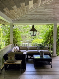 On the expansive wrap around porch is a very inviting space with this large, comfortable sectional for cool summer evening chats.