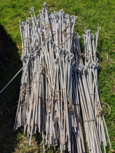 Instead of rings that are available at many garden centers, I use these metal stakes I designed myself for my farm. Each metal support has two eyes, one at the top and one in the middle. The stakes are about three feet tall.