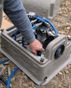 This is a rocking piston compressor that creates the air pressure needed for oxygenating the pond.