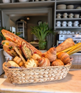 The buffet is set up with two large baskets of gorgeous homemade breads including slices of herb baguettes from MARTHA: THE COOKBOOK.