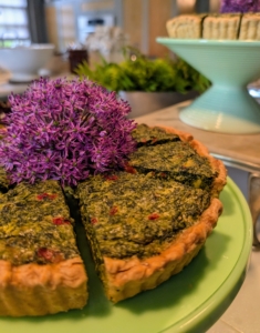 The spinach pie is decorated with one allium flowerhead from the garden.