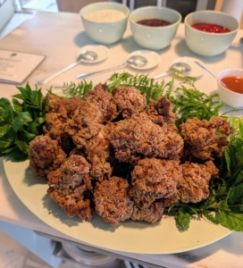 The fried chicken is plated with greens...