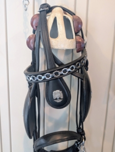 In my saddle tack room I keep other equipment - bridles, saddles, collars, and harnesses - also made by Freedman's. This bridle has the symbol of my farm on it, the great sycamore tree.