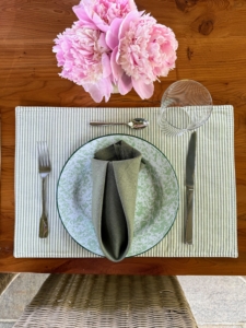 The table settings were done with my signature green color. I used fun enamel ware plates and coordinated with bright colored pink peonies.