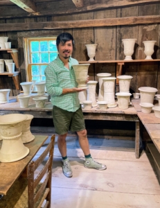 Here's devotee Bernie Wong looking at some of the lighter clay pots. On the side of his pots, Guy also stamps his name and the wet weight of the clay used. This standardized system for horticultural pots was adopted by Victorian potters.