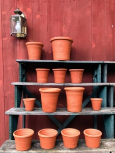 Guy displays some of his red terra cotta pots. These pots were made by Guy or his wife, Erica.