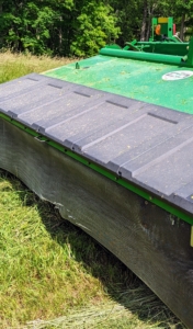 This is our mower-conditioner. Mower-conditioners are a staple of large-scale haymaking. It cuts, crimps, and crushes the hay to promote faster and more even drying. It is the first step in the hay baling process.