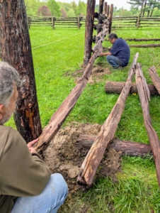 Once the posts are in place, Pete and Fernando secure the horizontal railings.