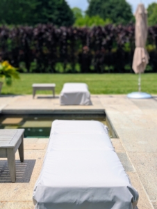 Around the pool, I have chaises longues and side tables from Restoration Hardware. The big square shade umbrellas are from TUUCI.