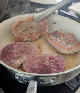 The pork should cook until it is golden brown and medium - it should have an internal temperature of 145-degrees Fahrenheit and cooked approximately two to three minutes per side.