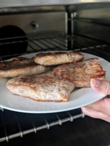 After it is cooked through, Enma places it on a plate and keeps it in a warm oven. One can also plate the pork and cover with aluminum foil to keep warm.