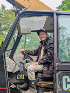 My outdoor grounds crew foreman, Chhiring Sherpa, sits in the Hi-Lo ready to move teammates safely from place to place. From ground level, he can also check the work done from a different vantage point.