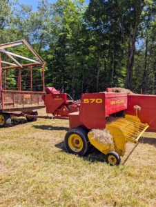 A hay baler is a piece of farm machinery used to compress a cut and raked crop into compact bales that are easy to handle, transport, and store. I am fortunate to have all the necessary equipment to process the hay in my fields.