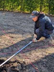 I always encourage my gardeners and outdoor grounds crew to measure everything. Here is Phurba marking the true center of each bed.