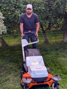 For very narrow spaces such as in between the rows of my dwarf apple espalier, Adan uses a STIHL RM 655 VS gas push mower. While I have replaced many grassy areas with mulch to reduce the amount of mowing around my farm, there is still a lot of mowing to do.