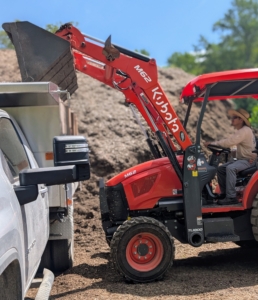Chhiring is using my Kubota M62 Tractor Loader Backhoe. It has a 63 horsepower engine, a front loader with a lift capacity of 3,960 pounds, and a powerful Kubota backhoe with 169.8 inch digging depth. Chhiring controls everything from the safety of the tractor’s cab. He can turn and sit facing either direction to maneuver the backhoe or the loader.