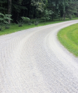 When the rake is lowered onto the road surface and tilted to the proper angle, the attachment moves the gravel and road dust to the center, creating a crown. On less used roads, the power rake freshens up the existing gravel as it turns and brings any compacted gravel to the surface. Pete just finished this section of road leading to my pastures.