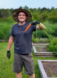 Ryan occasionally picks a vegetable to see how it is doing. Here's one of my carrots - looks really good! Most are familiar with the orange carrots, but they also grow in red, yellow, white, and purple.