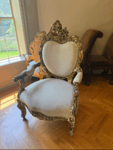 There is also a curated mix of chairs at the sale - antique, vintage and modern. This is an ornate Rococo-style armchair with a heart-shaped back and gilded details.