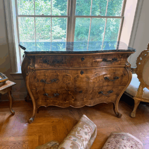 This exquisite antique bombe commode is crowned with a polished black marble top, richly veined in white for a striking, timeless contrast.