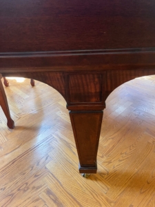 The mahogany body and legs are in pristine condition.