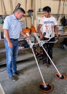 Here’s Brian Carolan from STIHL on the left. Brian always delivers the tools and shows the crew the proper way to use each one. Here he is showing Pasang the brush cutter and the STIHL FSA 400 42 CM 36V Lithium Ion Battery Powered Clearing Saw.