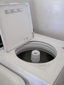 This washer is a top loader, so its door opens up. All Speed Queen washers and dryers are well known for their durability and strong performance. These models are also very quiet.
