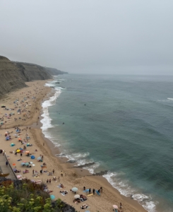 But also in Sintra is this beach - Praia de Magoito, an impressive and popular beach destination with its golden sand, tall, dark cliffs, and fossil dunes.