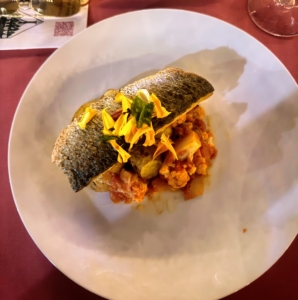 The entrée was grilled branzino with tomato braised cauliflower, fingerling potatoes, cerignola olives, basil, and a garnish of edible flowers.