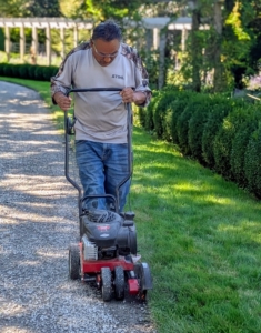It’s always important to wear long pants and closed shoes to avoid injury from any flying debris. Edgers can cause small stones to fly up to nearly 10-feet. Pete also wheres eye protection while using this machine. As it is running, Pete listens to the edger to guide the speed. The machine works harder when cutting through the turf and is generally quieter when it finishes.