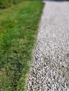 Here’s a finished edge – it looks so straight and clean. It’s important to edge and shape the roads regularly, so they drain properly and look tidy. I like to use native washed stone in a blend of gray tones. This gravel is used all over the farm.