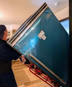 The team manually transports this unit into the kitchen the same way the old unit left - without marring any walls or furniture.