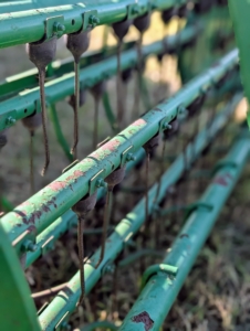 There are different kinds of rakes – they include wheel rakes, rotary rakes and parallel bar or basket rakes. This is a parallel bar rake. This type uses a gentle raking action with a lower chance of soil contamination than the wheel rake.
