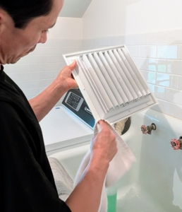Here, the vent covers are getting cleaned and wiped completely dry.