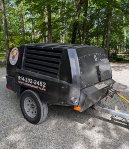 This is a portable diesel fuel air compressor, which provides high pressure clean air to help push the airflow toward the vacuum device.
