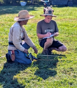 Ryan and Chhiring review the exact location for the lindens. The maze is drawn out on a map I designed, so it is very important to refer to it every time something new is added.