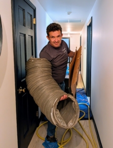 Once the top floor is completed, the vacuum and hoses are moved down to the basement, where they can be used to clean the vents and ducts in the downstairs zone of this house.
