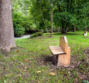 Debra's husband wanted to create a relaxing area by their stream, so they reached out to an artisan to make three of these benches - all hand made with custom selected woods. Debra uses the space for flower arranging workshops. (Photo courtesy of Bear Creek Farm)