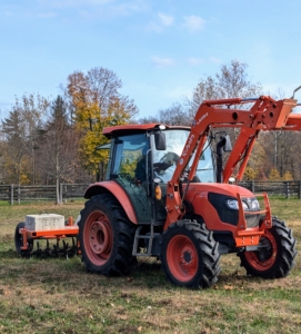 For this job, the M4-071 is seen with a Land Pride Tow-Behind Aerator working in the field.