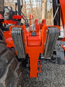The tractor’s stabilizing feet are extended to keep it well balanced and safe.