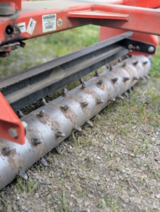 The Land Pride PR1690 Power Rake is secured to the back of our tractor in order to rake and grade the carriage roads. When the rake is lowered onto the road surface and tilted to the proper angle, this attachment moves the gravel and road dust to the center, creating a crown. On less used roads, the power rake freshens up the existing gravel as it turns and brings any compacted gravel to the surface.