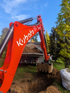 The backhoe is controlled from the safety of the tractor’s cab. The operator can turn and sit facing either direction to maneuver the backhoe or the loader.