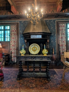 On one side is the Spanish alcove within the Music Room. It features a Gothic 16th century ceiling from an inn near Toledo, Spain. Chairs flank a 17th century Italian table. The Rosen family regularly gathered in this area to entertain and play board games.